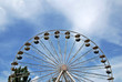 ferris wheel with trees on a blue sky