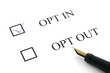 opt in and out options with a pen on white paper background opt in and out options with a pen on white paper background