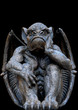Scary looking Gargoyle sitting inside his wings