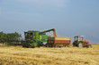 combine and tractor on harvest wheat field combine and tractor on harvest wheat field