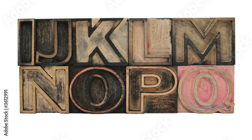 old, inkstained letterpress wood outline type letters I-Q old, inkstained letterpress wood outline type letters I-Q