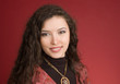 Woman in dress portrait isolated on red background
