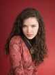 Woman in dress portrait isolated on red background