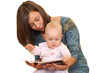 mother and 8 months baby girl reading book together 