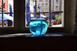 Vessel with a liquid in which the medieval city is reflected