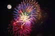 A fireworks display and a full moon.