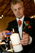 A groom lighting a candle in chapel