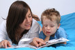 mother and three years old boy reading book - good night