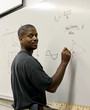 student at the board doing trigonometry. student at the board doing trigonometry.