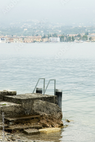a pier from stones in lake Garda a pier from stones in lake Garda