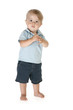 Boy of fifteen months standing barefoot over white background.