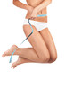 Beautiful woman measuring her waist - high key shot in studio Beautiful woman measuring her waist - high key shot in studio