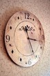 Ornamental Wall Clock on flowered wallpaper background
