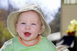 Cute baby boy in sunlight wearing a hat