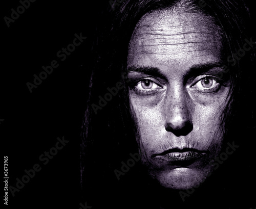Photo: Closeup Portrait of a very disturbed Woman on Black Closeup Portrait of a very disturbed Woman on Black