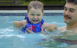 Father and his daughter's first dive. Focus on the child.
