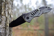 camouflage folding knife meant for hunting