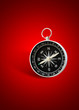 magnetic compass in red background with shadow