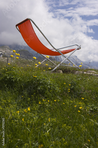 Photo: Chaise longue with a beautiful alpine scenic Chaise longue with a beautiful alpine scenic