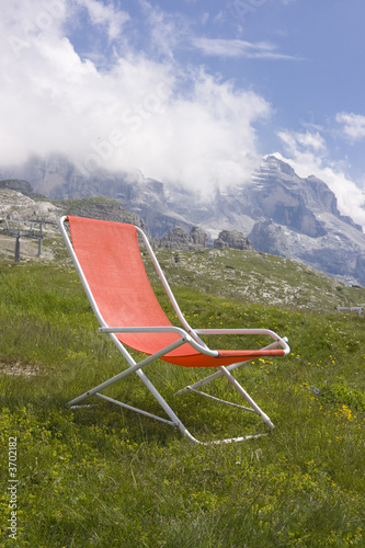 Photo: Chaise longue with a beautiful alpine scenic Chaise longue with a beautiful alpine scenic