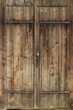 Locked wooden brown gate on a rural barn