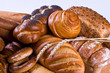 Variety of bread, bagels, buns and two wheat-ears.