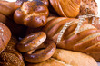 Variety of bread, bagels, buns and two wheat-ears. Close-up.