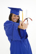 A female caucasian in navy blue graduation gown