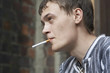 23 year old man is smoking the sigarette