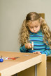 Girl helping to assemble a new furniture Girl helping to assemble a new furniture