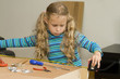 Girl helping to assemble a new furniture Girl helping to assemble a new furniture