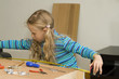 Girl helping to assemble a new furniture Girl helping to assemble a new furniture