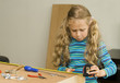 Girl helping to assemble a new furniture Girl helping to assemble a new furniture
