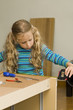 Girl helping to assemble new furniture Girl helping to assemble new furniture
