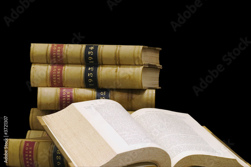 A stack of old law reports on a black background. A stack of old law reports on a black background.