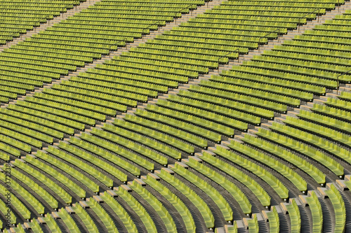 Photo: Empty green seating at an event Empty green seating at an event