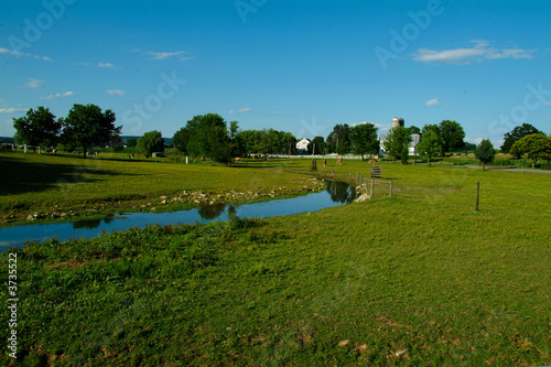 Photo: Horse Farm in Lancaster PA with brook in foreground and blue sky Horse Farm in Lancaster PA with brook in foreground and blue sky