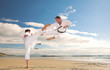 Young adult men practicing Karate on the beach