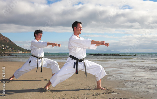 Photo: Young adult men with black belt practicing a Kata Young adult men with black belt practicing a Kata