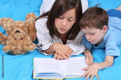 mother and five years old boy reading book - good night mother and five years old boy reading book - good night