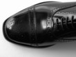 Black Brogues over white background..