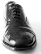 Black Brogues over white background..