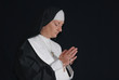 Middle aged devout nun in deep thoughts, praying. Middle aged devout nun in deep thoughts, praying.
