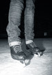 Female legs in jeans and skates