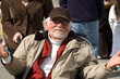 older man in wheelchair gesturing
