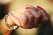 Red glamour fingernails and a wrist watch woman hand