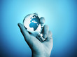 A man holding a bulb with the world on it.