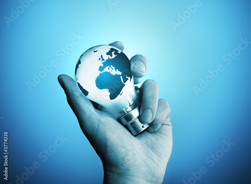 Photo: A man holding a bulb with the world on it. A man holding a bulb with the world on it.