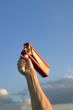 Hand waving a traditional football rattle in the air.