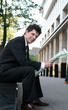 Businessman reading newspaper outdoors